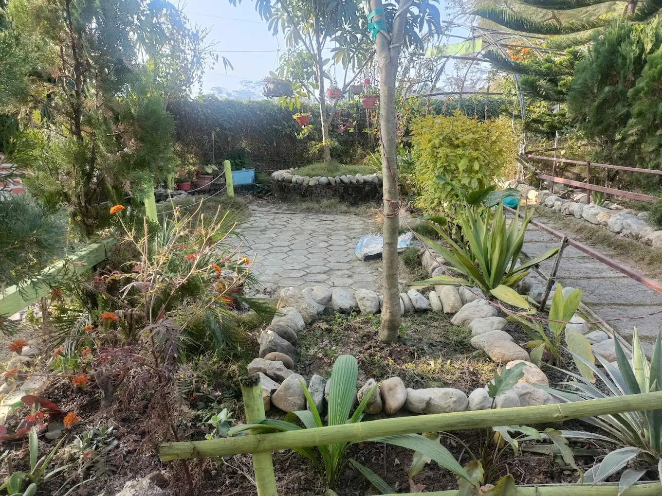 Outdoor garden seating area with stone paths at Peace Garden Restaurant Thecho